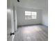 Spacious bedroom featuring wood-look flooring and large window at 5329 Hansel Ave # B-4, Edgewood, FL 32809