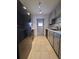 Kitchen with gray cabinets, black appliances and tile floor at 5329 Hansel Ave # B-4, Edgewood, FL 32809