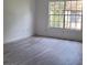 Spacious bedroom with large window and gray laminate flooring at 5329 Hansel Ave # B-4, Edgewood, FL 32809