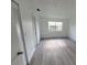 Simple bedroom with grey vinyl flooring and large window at 5329 Hansel Ave # B-4, Edgewood, FL 32809