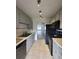 Bright kitchen features gray cabinets, black appliances, and tile flooring at 5329 Hansel Ave # B-4, Edgewood, FL 32809