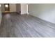 Open living area showcasing gray laminate flooring at 5329 Hansel Ave # B-4, Edgewood, FL 32809