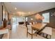 Open concept dining area with a large wooden table and modern lighting at 4063 Lana Ave, Davenport, FL 33897