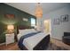 Main bedroom with tufted headboard, nightstands, and en-suite bathroom at 4063 Lana Ave, Davenport, FL 33897