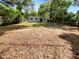 Spacious backyard with grassy area and wood chips at 613 Alpine St, Altamonte Springs, FL 32701