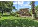 Large backyard with lush lawn and a patio area with a pergola at 2881 St George Dr, Davenport, FL 33837