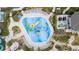 Aerial view of a vibrant spray park with multiple water features and lounging areas at 1158 Drop Ln, Davenport, FL 33896