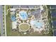 Aerial view of community pool area with water slides, expansive deck, and lounging areas at 1158 Drop Ln, Davenport, FL 33896