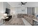 Bright living room featuring a sectional sofa and a large TV at 1158 Drop Ln, Davenport, FL 33896
