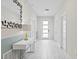 Clean entryway with white walls, tile floors and modern decor at 1158 Drop Ln, Davenport, FL 33896