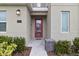 Modern front entrance with red door and glass panels at 1158 Drop Ln, Davenport, FL 33896