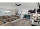 Open concept living room with sectional sofa and views to kitchen and dining areas at 1158 Drop Ln, Davenport, FL 33896