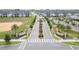 Aerial view of community entrance with landscaped medians and gated access at 1158 Drop Ln, Davenport, FL 33896