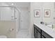 Main bathroom with double sinks, a large shower, and marble floors at 1158 Drop Ln, Davenport, FL 33896