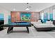 Game room featuring twin beds, pool table, and brick feature wall at 1158 Drop Ln, Davenport, FL 33896