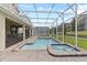 Relaxing pool and spa with a screened enclosure at 1158 Drop Ln, Davenport, FL 33896