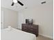 King-size bed in a bedroom with dresser and TV at 1158 Drop Ln, Davenport, FL 33896