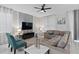 Spacious living room with sectional sofa, large TV, and ample natural light at 1158 Drop Ln, Davenport, FL 33896