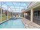 Refreshing pool and spa with screened enclosure and patio at 1158 Drop Ln, Davenport, FL 33896