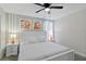 King bedroom with white furniture and ceiling fan at 1158 Drop Ln, Davenport, FL 33896