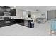 Open concept kitchen with island, stainless steel appliances and view into living room at 1158 Drop Ln, Davenport, FL 33896