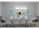 Modern dining room with white table, gold accents, and statement light fixture at 1158 Drop Ln, Davenport, FL 33896