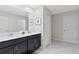 Bathroom with double vanity, dark cabinets, and marble floor at 1158 Drop Ln, Davenport, FL 33896