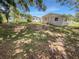 Spacious backyard with mature trees, grassy area, and home view at 260 Pineview Dr, Oviedo, FL 32765