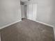 Spacious bedroom with neutral walls and carpeting, and double doors to closet at 260 Pineview Dr, Oviedo, FL 32765