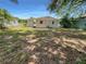 Large backyard with grassy area and mature trees at 260 Pineview Dr, Oviedo, FL 32765