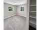 Bright bedroom with neutral carpeting, double windows, and built-in shelving at 260 Pineview Dr, Oviedo, FL 32765