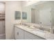 Double vanity bathroom with granite countertop and large mirror at 218 Great Yarmouth Ct, Kissimmee, FL 34758