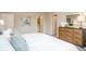 Spacious main bedroom with ample natural light, dresser, and access to a bathroom at 218 Great Yarmouth Ct, Kissimmee, FL 34758