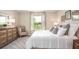 Main bedroom with plush bedding, a dresser and an ensuite bathroom at 218 Great Yarmouth Ct, Kissimmee, FL 34758