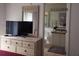 Bedroom with en-suite bath and dresser at 1107 Park Ridge Cir, Kissimmee, FL 34746