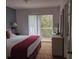 Bedroom with king-size bed and access to balcony at 1107 Park Ridge Cir, Kissimmee, FL 34746