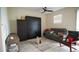Living area with gray sectional sofa and a wall bed at 4832 Tribute Trl, Kissimmee, FL 34746