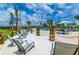 Relaxing sandy beach area with lounge chairs at 4832 Tribute Trl, Kissimmee, FL 34746