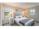 Bedroom with queen-size bed, nightstands, and large windows at 233 Macaulay S Cv, Haines City, FL 33844