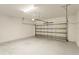 Attached garage with light-grey walls and floor at 233 Macaulay S Cv, Haines City, FL 33844