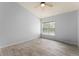 Spacious bedroom with ceiling fan and large window at 4368 S Kirkman Rd # 212, Orlando, FL 32811