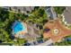 Aerial view of community pool and surrounding area with palm trees, parking and building at 4368 S Kirkman Rd # 212, Orlando, FL 32811