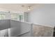 Open living room with wood-look tile flooring, high ceilings, and access to a balcony at 4368 S Kirkman Rd # 212, Orlando, FL 32811