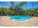 Community pool with brick deck and lounge chairs at 4368 S Kirkman Rd # 212, Orlando, FL 32811