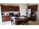 Modern kitchen with stainless steel appliances and an island at 462 Hamlet Loop, Davenport, FL 33837