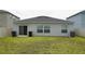 Home's back elevation and yard at 462 Hamlet Loop, Davenport, FL 33837