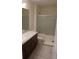 Clean bathroom with a tub, double vanity, and tile floor at 462 Hamlet Loop, Davenport, FL 33837