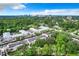 Wide aerial showcasing the community and distant cityscape at 700 Melrose Ave # E-6, Winter Park, FL 32789