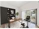 Home office with built-in shelving, desk, and exercise bike at 38 W Harding St # B, Orlando, FL 32806