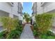 Peaceful courtyard with brick pathway and lush greenery between townhomes at 38 W Harding St # B, Orlando, FL 32806